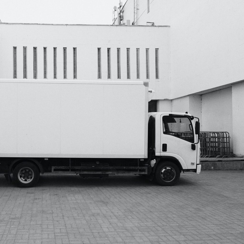 white truck parked near white building