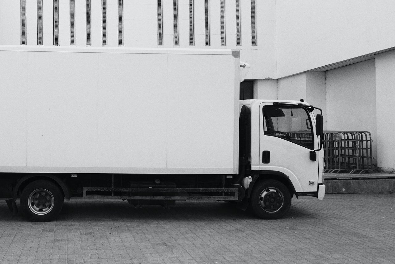 white truck parked near white building