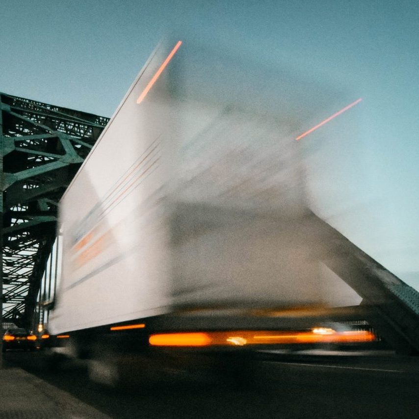 time lapse photography of truck going on bridge
